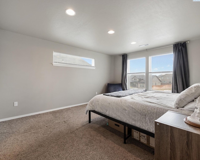 carpeted bedroom featuring baseboards, visible vents, and recessed lighting