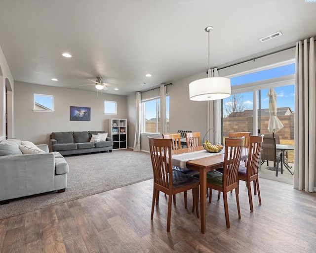 dining area with arched walkways, ceiling fan, recessed lighting, wood finished floors, and visible vents