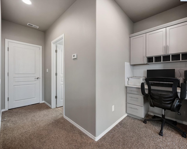 home office with carpet floors, visible vents, and baseboards