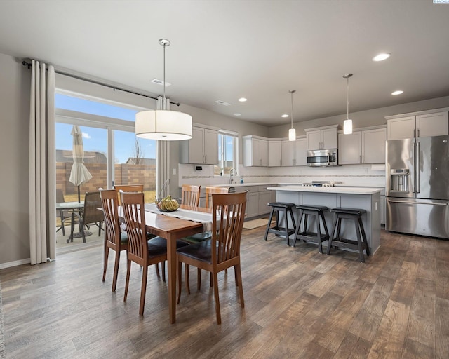 dining room featuring dark wood finished floors, visible vents, and recessed lighting