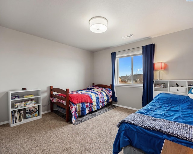 carpeted bedroom featuring visible vents and baseboards