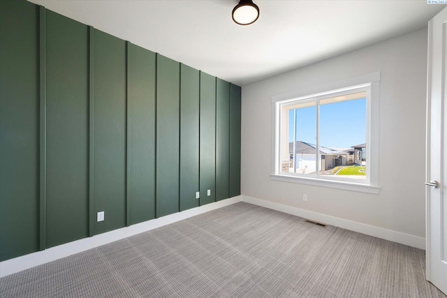 empty room featuring light colored carpet