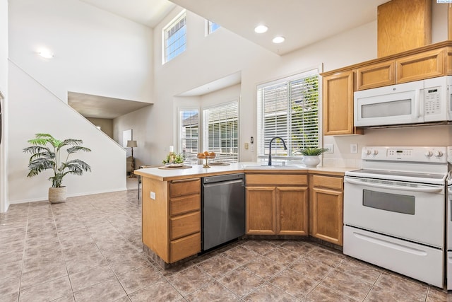 4611 Arabian Ln, Pasco, WA 99301 - kitchen featuring white appliances, light countertops, light tile patterned floors, and a high ceiling