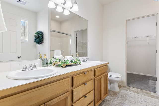 4611 Arabian Ln, Pasco, WA 99301 - bathroom featuring a shower stall, a walk in closet, and double vanity