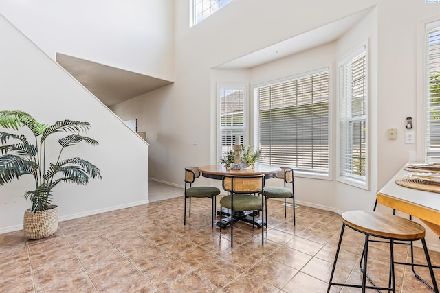 4611 Arabian Ln, Pasco, WA 99301 - dining area with plenty of natural light, light tile patterned flooring, a towering ceiling, and stairway