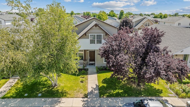 4611 Arabian Ln, Pasco, WA 99301 - obstructed view of property featuring a residential view, a front lawn, and covered porch