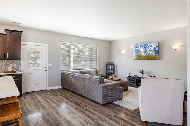 living room with dark wood finished floors and baseboards