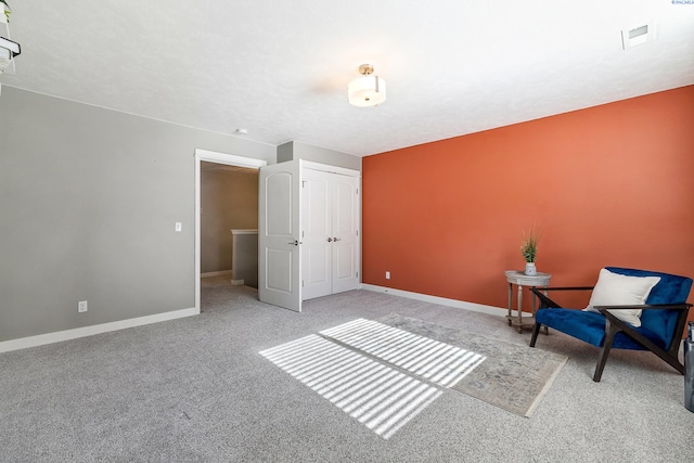 unfurnished room with visible vents, baseboards, and carpet flooring