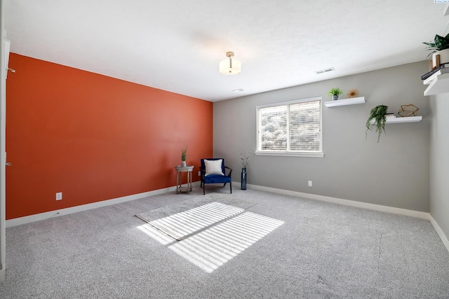 unfurnished room with light carpet, visible vents, and baseboards