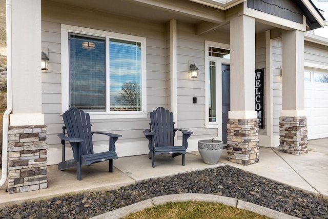 view of patio with a garage and covered porch