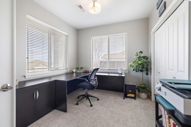 office area with light colored carpet, visible vents, and plenty of natural light