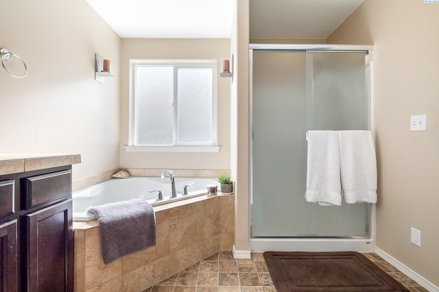 bathroom with a stall shower and a bath