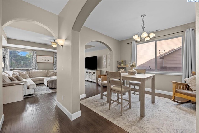 5200 W 28th Ave, Kennewick, WA 99338 - dining space featuring arched walkways, baseboards, a chandelier, dark wood-style flooring, and ceiling fan