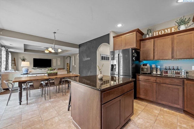 5200 W 28th Ave, Kennewick, WA 99338 - kitchen featuring arched walkways, recessed lighting, open floor plan, dark stone countertops, and light tile patterned floors