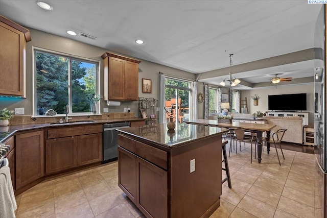 5200 W 28th Ave, Kennewick, WA 99338 - kitchen with dishwasher, a sink, a breakfast bar area, a center island, and open floor plan