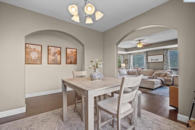 5200 W 28th Ave, Kennewick, WA 99338 - dining area with arched walkways, a chandelier, wood finished floors, baseboards, and a ceiling fan