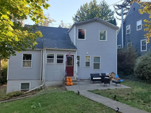 rear view of house with a patio, an outdoor living space, a shingled roof, entry steps, and a yard