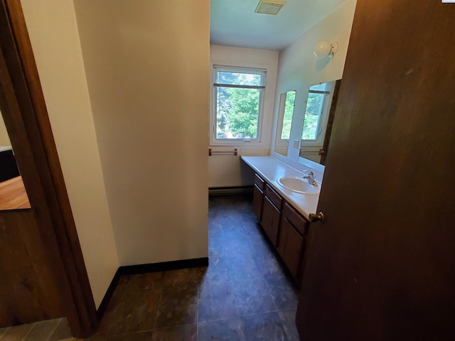 bathroom with visible vents, vanity, a baseboard radiator, baseboards, and tile patterned floors