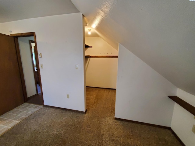 bonus room with baseboards, carpet flooring, and lofted ceiling