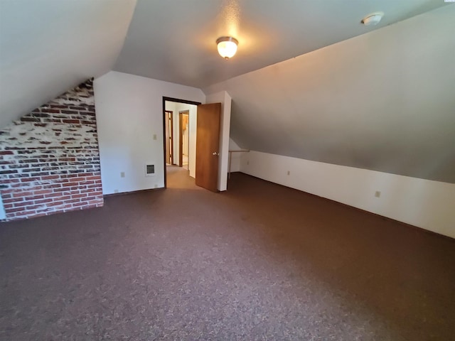additional living space featuring visible vents, carpet, and vaulted ceiling