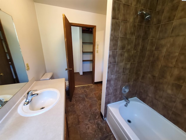 bathroom with vanity, baseboards, and bathtub / shower combination