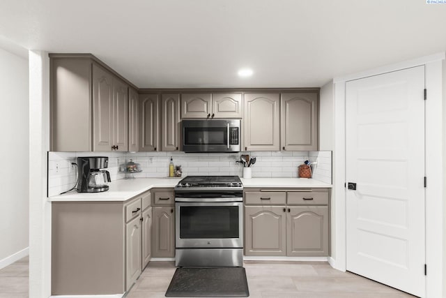 1335 W Grandview Ave, Sunnyside, WA 98944 - kitchen with stainless steel appliances, gray cabinetry, and decorative backsplash