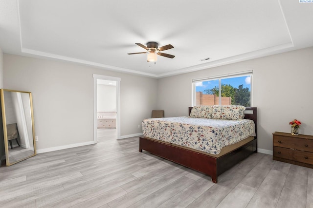 1335 W Grandview Ave, Sunnyside, WA 98944 - bedroom featuring a tray ceiling, light wood-style floors, ceiling fan, and ensuite bath