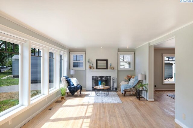 1935 Harris Ave, Richland, WA 99354 - living area with a brick fireplace, light wood-type flooring, and ornamental molding