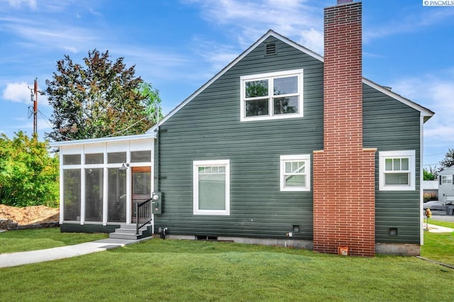 1935 Harris Ave, Richland, WA 99354 - rear view of property with a chimney, a sunroom, and a lawn