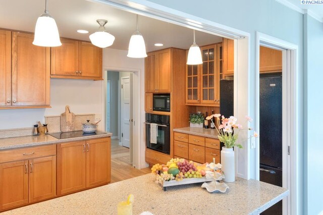 1935 Harris Ave, Richland, WA 99354 - kitchen featuring black appliances, glass insert cabinets, pendant lighting, light stone countertops, and recessed lighting