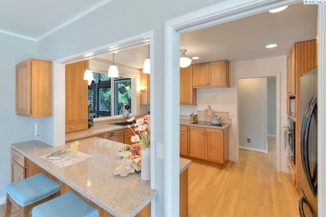 1935 Harris Ave, Richland, WA 99354 - kitchen with fridge, light wood-style floors, light stone counters, a peninsula, and a breakfast bar area