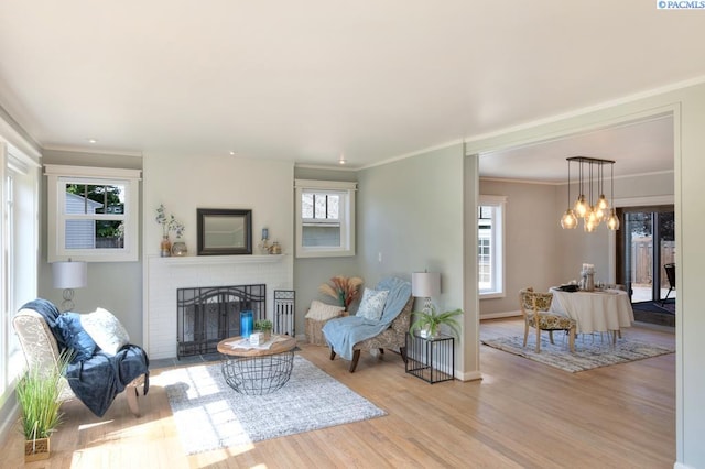 1935 Harris Ave, Richland, WA 99354 - living area with a brick fireplace, wood finished floors, ornamental molding, and a chandelier