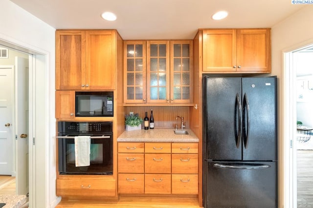 1935 Harris Ave, Richland, WA 99354 - kitchen with black appliances, glass insert cabinets, and recessed lighting