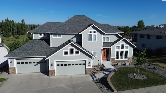 970 SW Itani Dr, Pullman, WA 99163 - view of front of property featuring stone siding, driveway, and a shingled roof