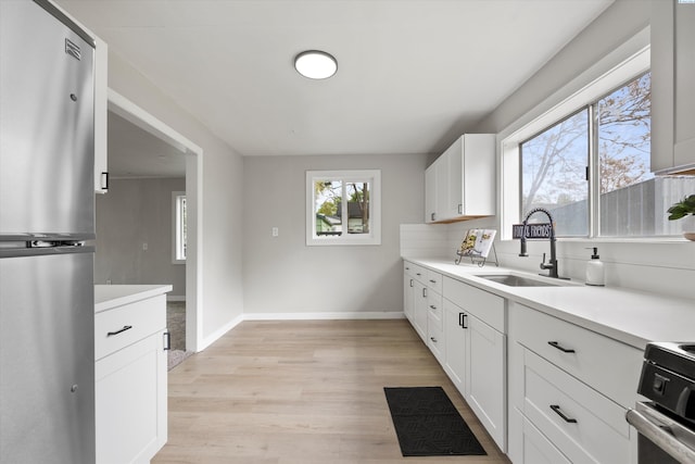 447 S Wilbur Ave, Walla Walla, WA 99362 - kitchen featuring stove, a sink, light countertops, and freestanding refrigerator
