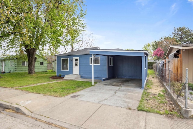447 S Wilbur Ave, Walla Walla, WA 99362 - view of front of house featuring driveway, a front lawn, fence, and a carport