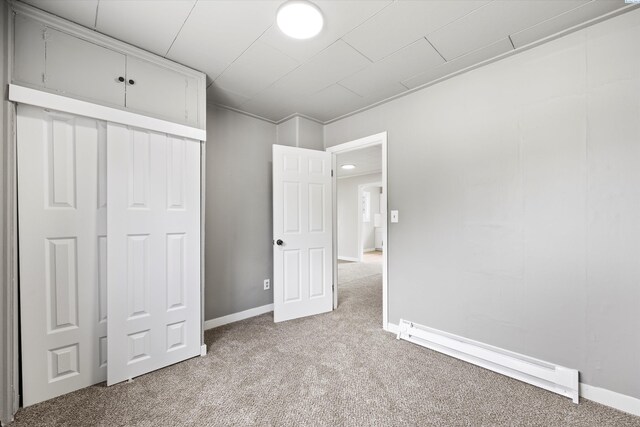 447 S Wilbur Ave, Walla Walla, WA 99362 - unfurnished bedroom featuring a baseboard radiator, baseboards, and light colored carpet