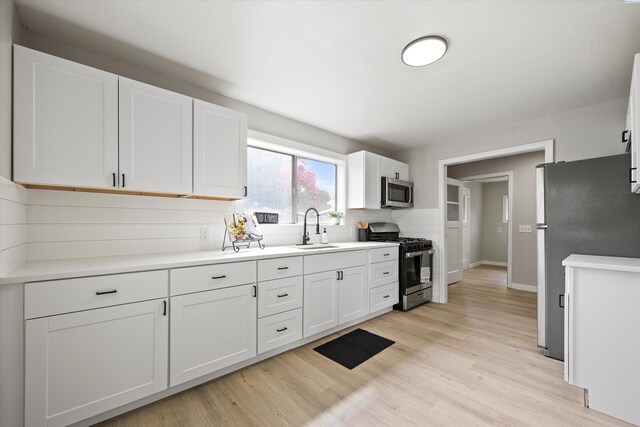 447 S Wilbur Ave, Walla Walla, WA 99362 - kitchen with a sink, light wood finished floors, light countertops, white cabinets, and appliances with stainless steel finishes