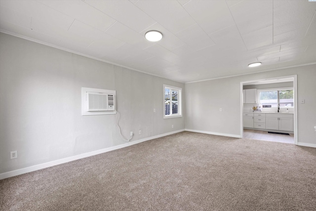 447 S Wilbur Ave, Walla Walla, WA 99362 - empty room with a sink, baseboards, light colored carpet, a wall mounted air conditioner, and crown molding