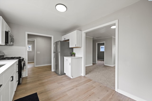 447 S Wilbur Ave, Walla Walla, WA 99362 - kitchen featuring white cabinetry, stainless steel appliances, light wood-style floors, and light countertops