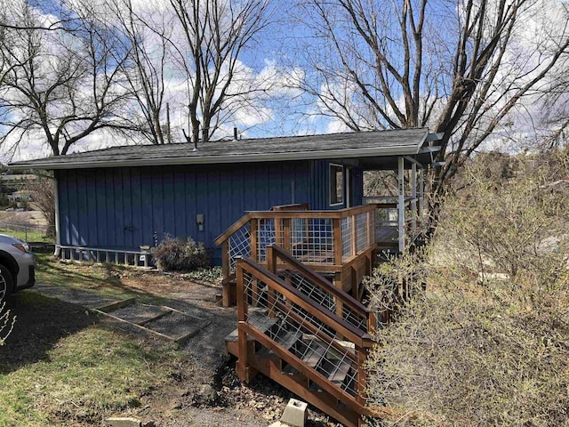 rear view of house featuring a wooden deck