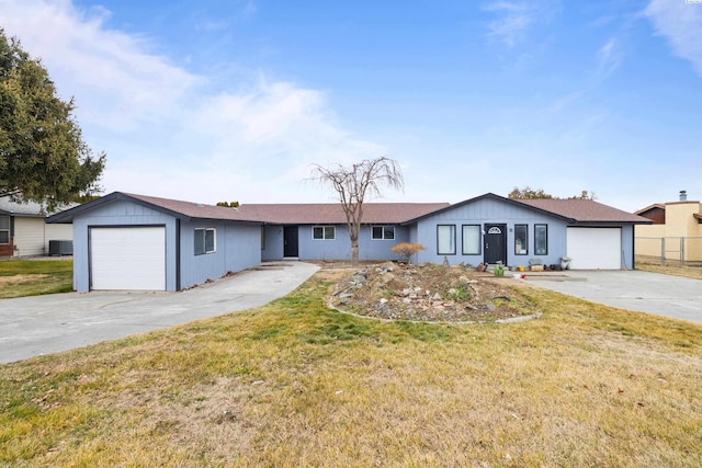 ranch-style house with a garage and a front lawn