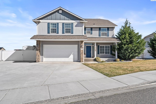 5601 Santa Fe Ln, Pasco, WA 99301 - view of front of house featuring board and batten siding, fence, a garage, driveway, and a gate