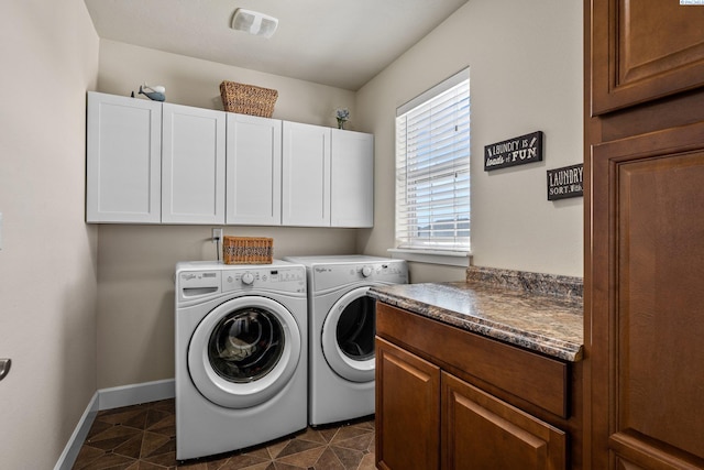 5601 Santa Fe Ln, Pasco, WA 99301 - clothes washing area featuring baseboards, visible vents, dark tile patterned flooring, separate washer and dryer, and cabinet space