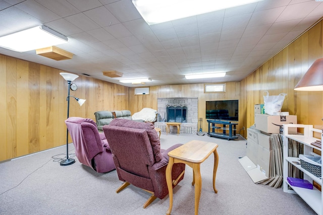 609 N Perkins Ave, Colfax, WA 99111 - living area with carpet floors, wood walls, and a fireplace