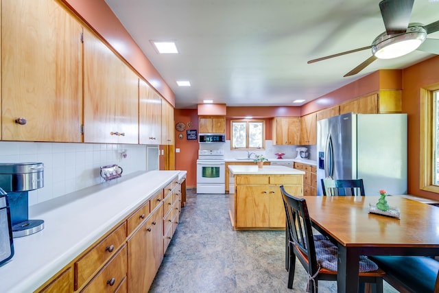 609 N Perkins Ave, Colfax, WA 99111 - kitchen featuring stainless steel appliances, ceiling fan, light countertops, a kitchen island, and tasteful backsplash