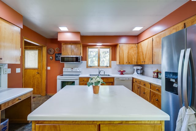 609 N Perkins Ave, Colfax, WA 99111 - kitchen featuring appliances with stainless steel finishes, a sink, decorative backsplash, light countertops, and brown cabinets