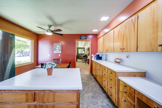 609 N Perkins Ave, Colfax, WA 99111 - kitchen featuring light countertops, ceiling fan, freestanding refrigerator, a center island, and decorative backsplash