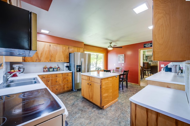 609 N Perkins Ave, Colfax, WA 99111 - kitchen featuring stainless steel fridge, white electric range oven, a sink, a kitchen island, and light countertops