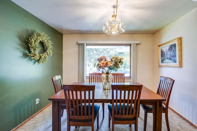 609 N Perkins Ave, Colfax, WA 99111 - dining area featuring light colored carpet, baseboards, and a chandelier